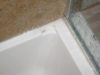 Cracked fiberglass shower base corner
