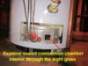 Gas water heater maintenance - examine sealed combustion chamber through the sight glass