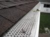 Rain gutter maintenance - leaf guard (white color visible on the picture) helps to maintain clean gutters