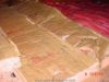 Improperly installed attic floor insulation - exposed flammable paper and double vapor retarder
