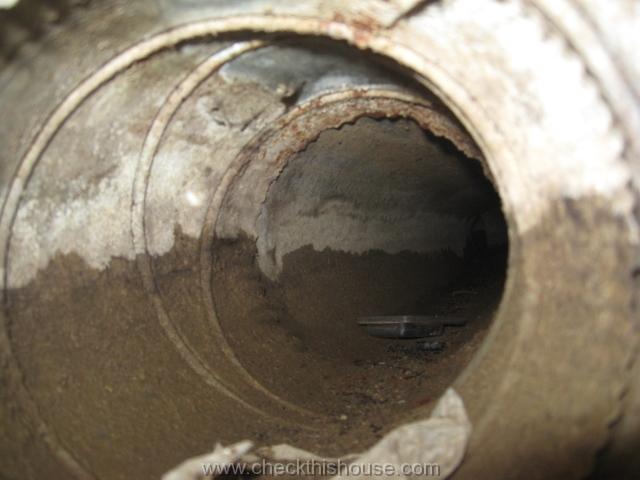 musty smell from air ducts high water line visible on interior walls of an air duct installed under the concrete floor