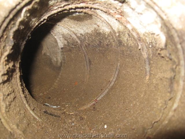 musty smell from air ducts wet and contaminated interior of the forced air heating system ducts installed under the house concrete floor