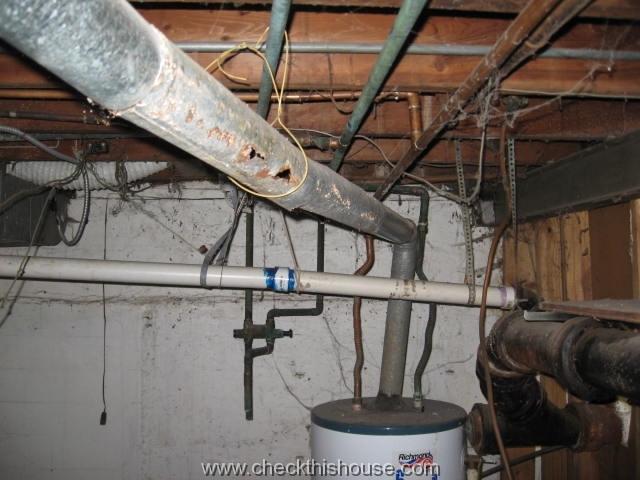 severely corroded water heater vent pipe poses safety hazard possibility of carbon monoxide poisoning
